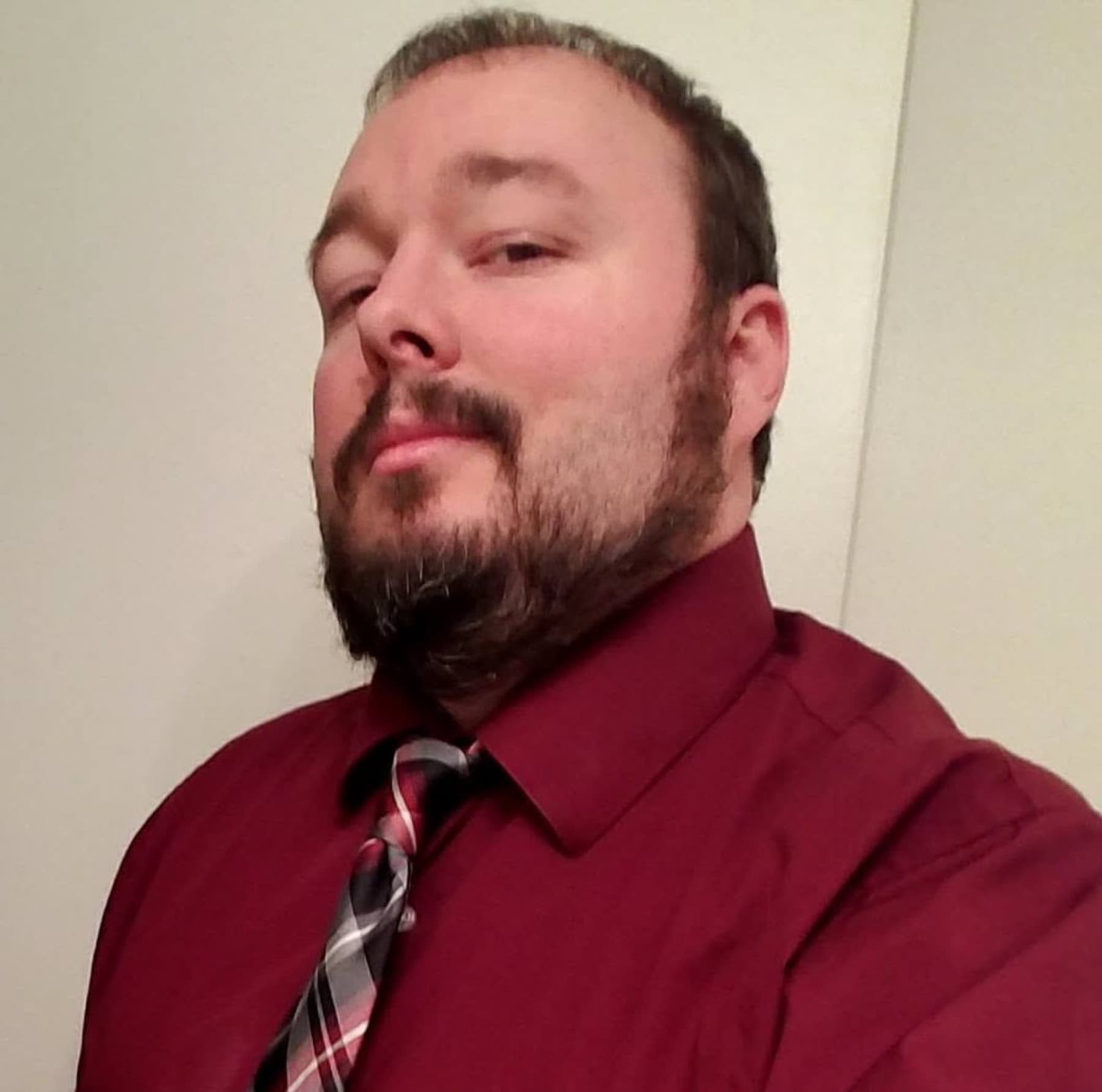 Jawa (Shawn, @JawaMeta) in a burgundy dress shirt and plaid tie